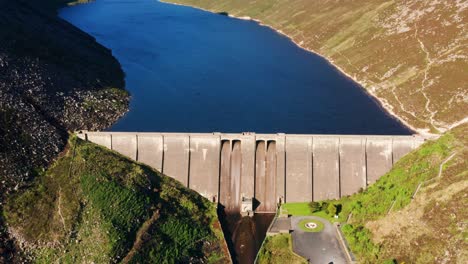 forward-panning aerial shot revealing ben crom dam in the mourne mountains