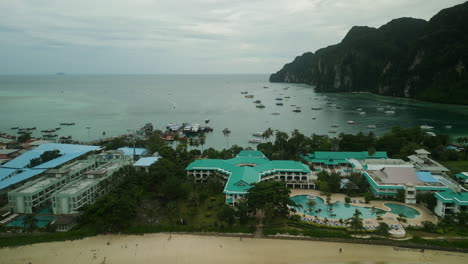 aerial view of a tropical bay with resort, beach, and boats