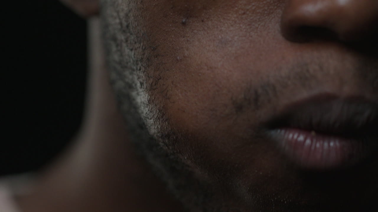 Close-up of a man's face with dirt or dust on his chin