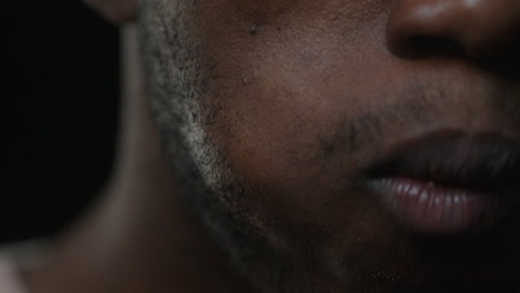 close-up of a man's face with dirt or dust on his chin