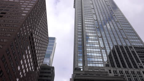 high-rise buildings reflect sky and clouds