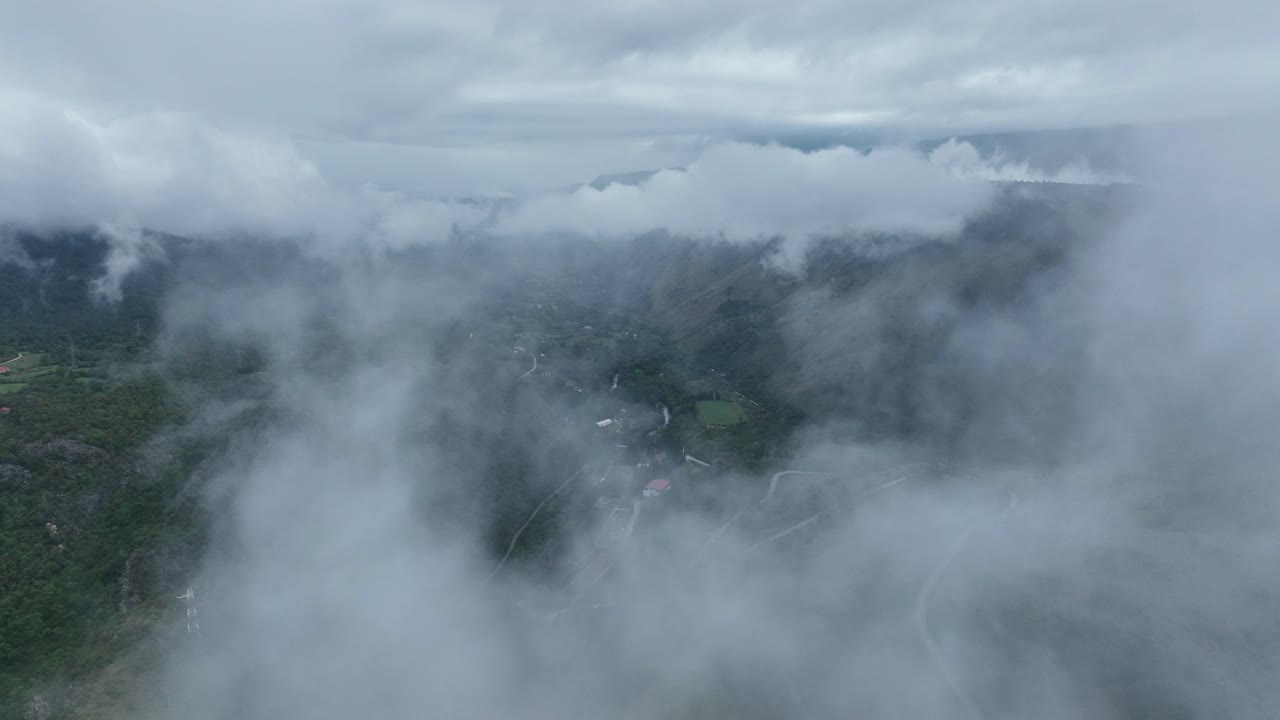 Flying Through The Clouds Over The Mountain With Winding Road In Cetinje, Montenegro. - aerial shot