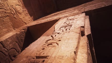 camera rotates arounda pillar, looking up at the carved hierogplyhs in the kamak temple in luxor, egypt.