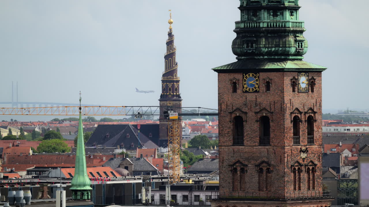 Copenhagen cityscape showcasing historic church spires, urban development, and the Oresund Bridge. Denmark