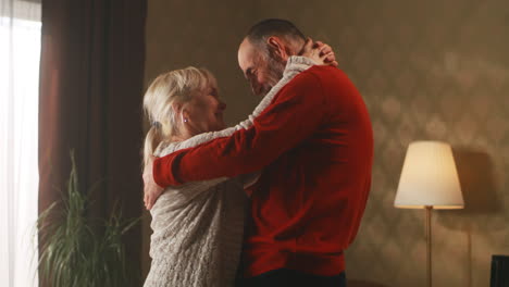 older couple dancing at home
