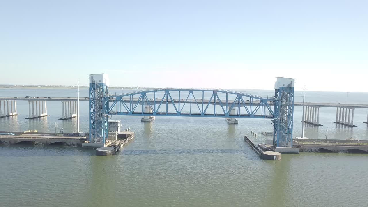 Blue Galveston Old Highway 75 Bridge Drone Shoot, Establishing Drone Shoot of Galveston old Causeway. Aerial shot of the The George and Cynthia Mitchell Memorial. 4k Dolly out drone shot.