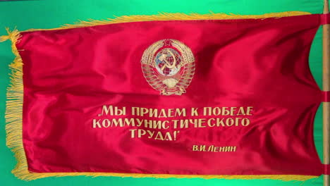 Red-Soviet-parade-flag-flies-from-flag-pole-with-green-screen-background-for-compositing
