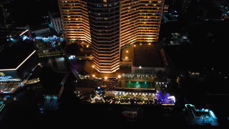 aerial tilt shot rising in front of the royal orchid sheraton, night in bangkok