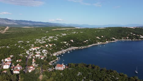 beautiful high 4k aerial footage over krk croatia with yachts and woods and the shoreline in sight