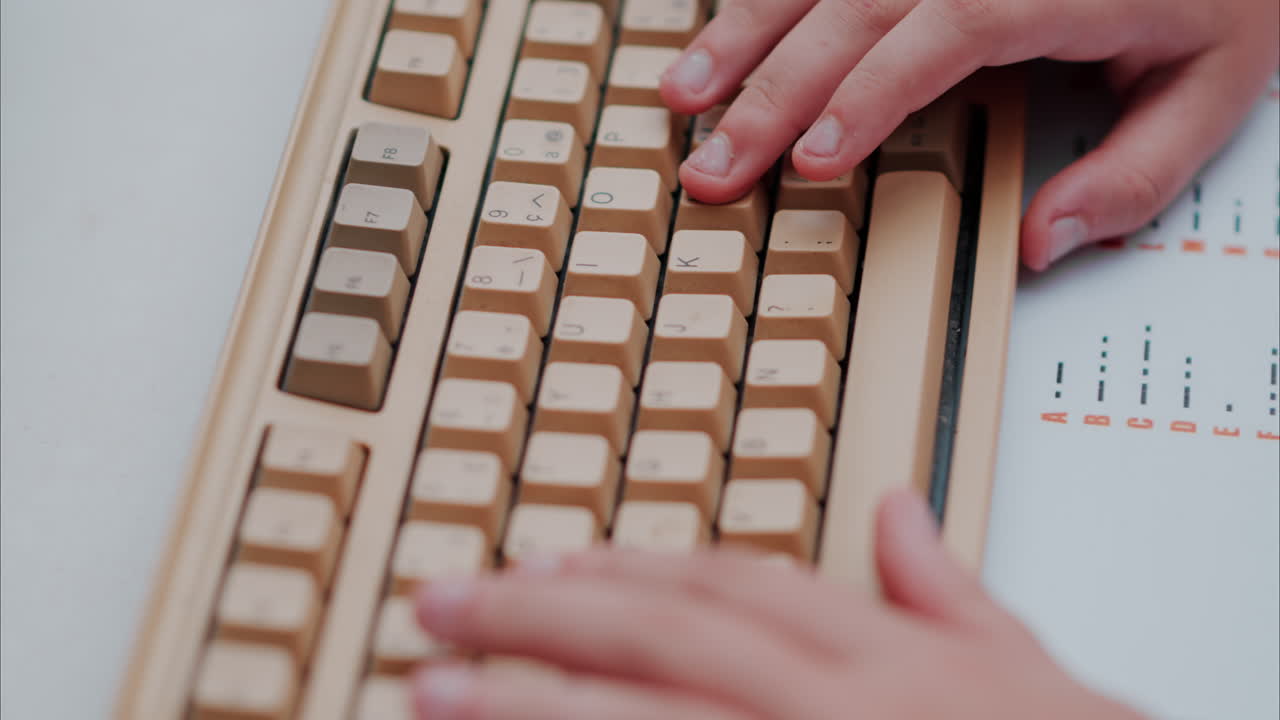 People writing on a white laptop keyboard with a morse code decipher