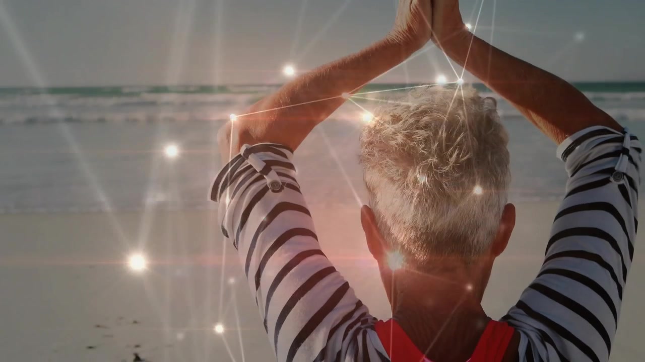 Senior woman sitting shore raising arms pressing palms starting nodes glowing on body for health
