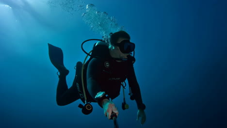 a scuba diver takes an underwater selfie