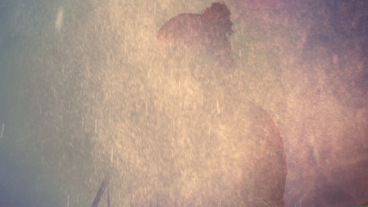 Man standing behind mist haze, showcasing music stage environment with animated particles