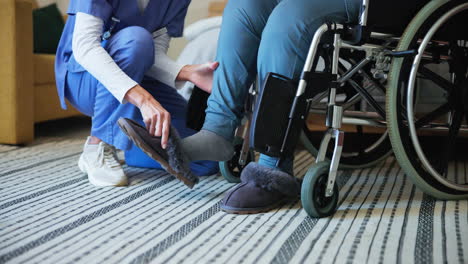 nurse helping patient put on slippers