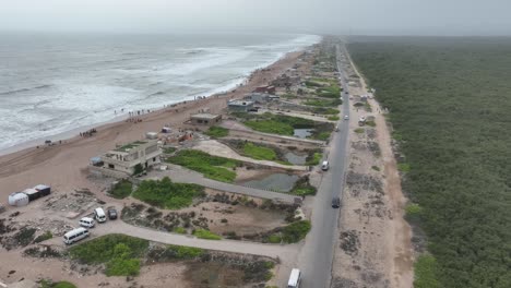 Aerial-View-Of-Beach-Huts-Beside-Hawkes-Bay-And-Mangrove-Forest-Plantation-In-Karachi