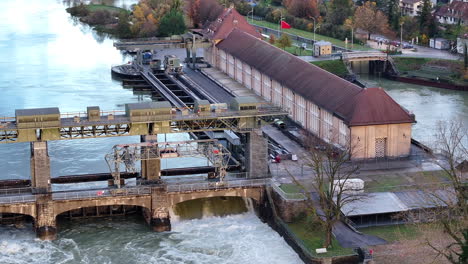 rhine river high water level at hydroelectric power plant augst switzerland, drone pan 4k