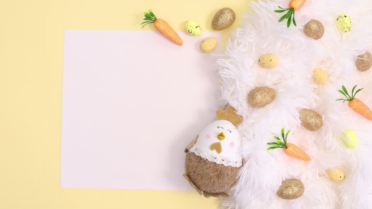 Easter white and gold decoration and paper card note on bright yellow background. Stop motion flat lay