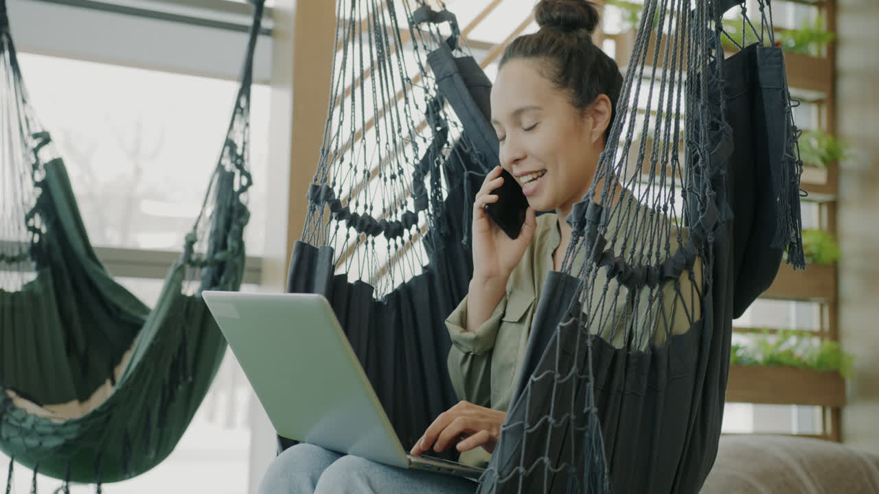 Woman working in a hammock