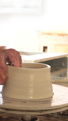 female potter making a pot