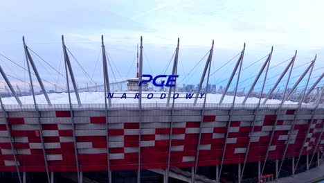 drone shot of exterior and logo sign on national football stadium in warsaw, poland. pge narodowy