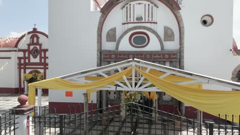 drone-flying-bottom-up-of-Old-stone-gothic-church-door-and-the-entrance-in-Mexico