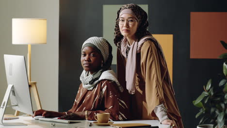 young muslim women posing in office