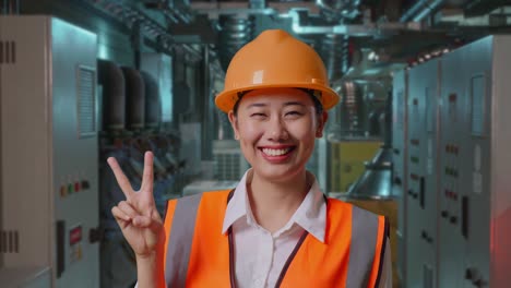 smiling female engineer in factory