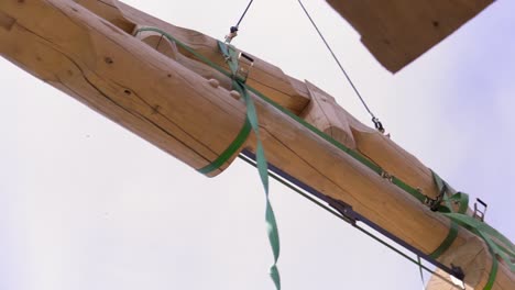 wooden beam support with green straps