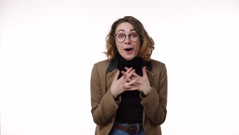 over excited female with curly hairstyle, laughs happily, expresses sincere emotions, being amused by good news. happy young female in jacket and jeans gesturing, super surprised