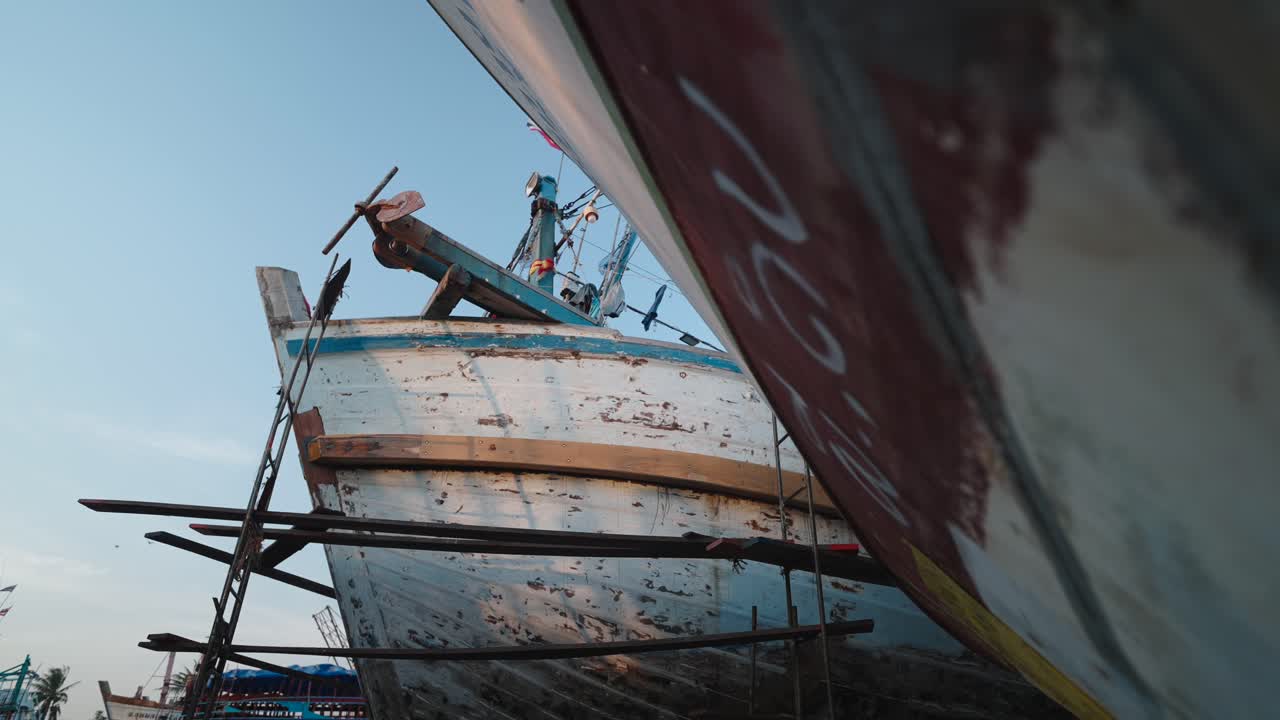 Old Fishing Boats Under Repair in Harbor