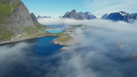 flying-over-the-clouds-and-between-mountains-in-the-city-of-Reine-with-beautiful-colors