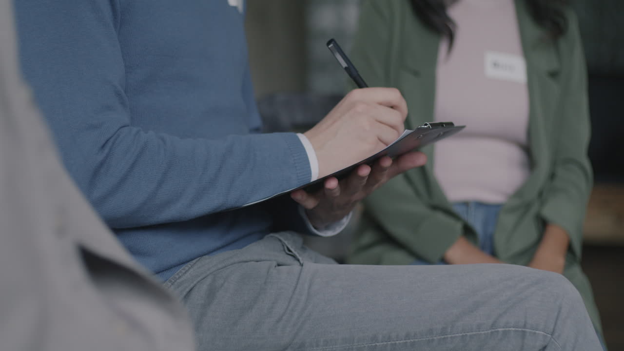 People Taking Notes in a Meeting