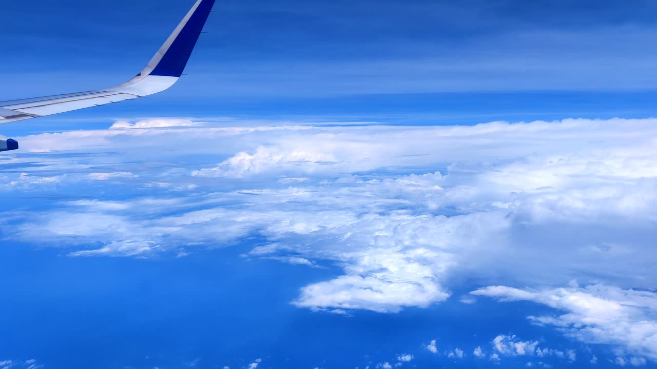 Flying over multiple layered high altitude cloud mountain formed over sea