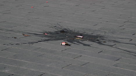 Broken-glass-bottle-on-grey-pavement.-4K