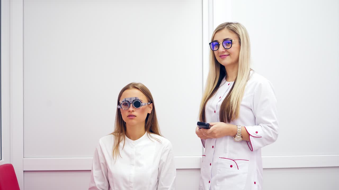 Beautiful woman on the consultation of an ophthalmologist. Eye examination and selection of spectacle lenses. Female doctor helps patient to choose eyeglasses in clinic.