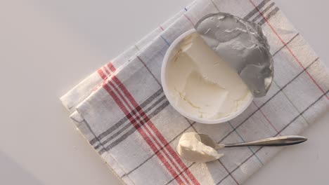 cream cheese in a container with spoon