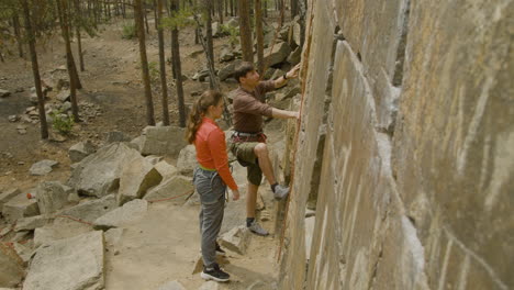 climbers at the bottom of the cliff