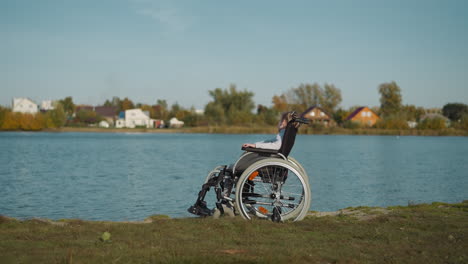 Little girl with spinal cord injury looks at river village