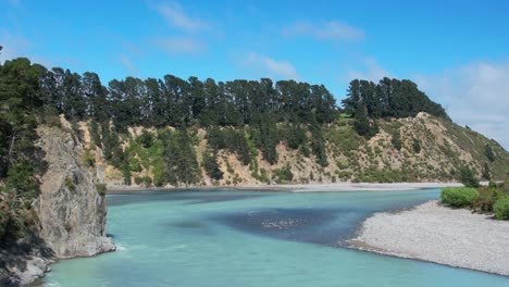 Slow-aerial-approach-to-gorge-above-beautiful-turquoise-colored-Waimakariri-River-in-summertime