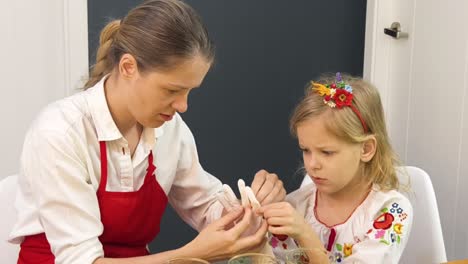 mother and daughter making a craft together