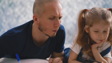 dad and little daughter do home teaching