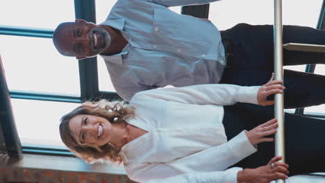retrato de video vertical de un equipo de negocios multicultural sonriente de pie juntos en una oficina moderna