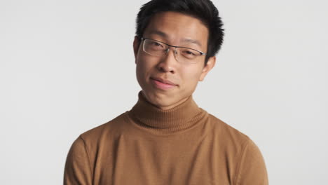 asian man in eyeglasses looking at the camera.