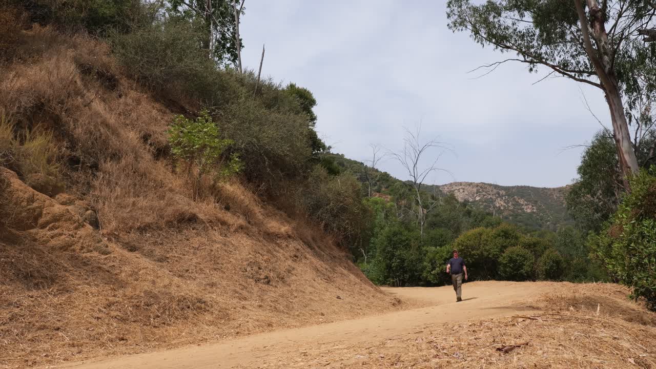 Man hikes on trail in Griffith Park in Los Angeles