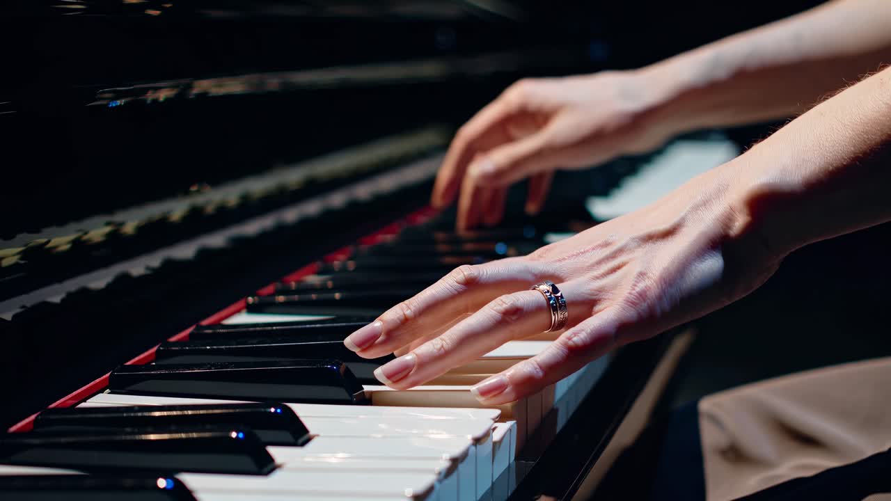 Close-up of Musician's Hands Playing Grand Piano Keys