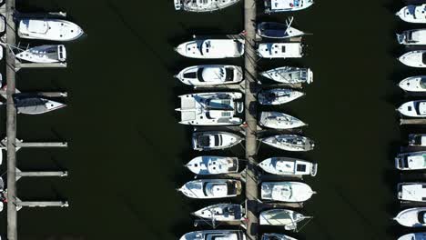 top down view of million dollar yachts and luxury boats in a marina