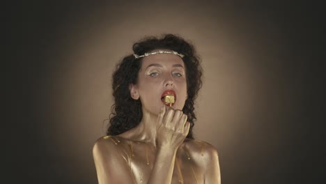 woman with gold body paint and candy