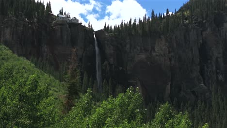telluride bridal veil falls waterfall colorado powerplant house aerial drone circle left sun aspen trees uncompahgre forest summer green box canyon black bear pass road rocky mountains 4wd blue sky