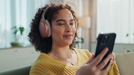 woman relaxing at home listening to music with headphones
