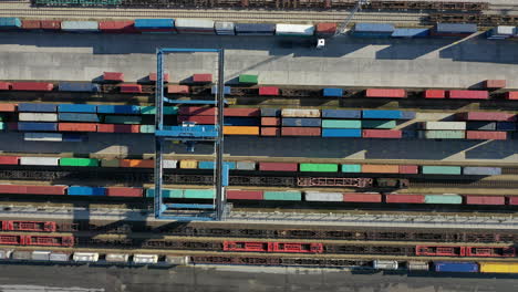 large cargo crane moves around containers from trains